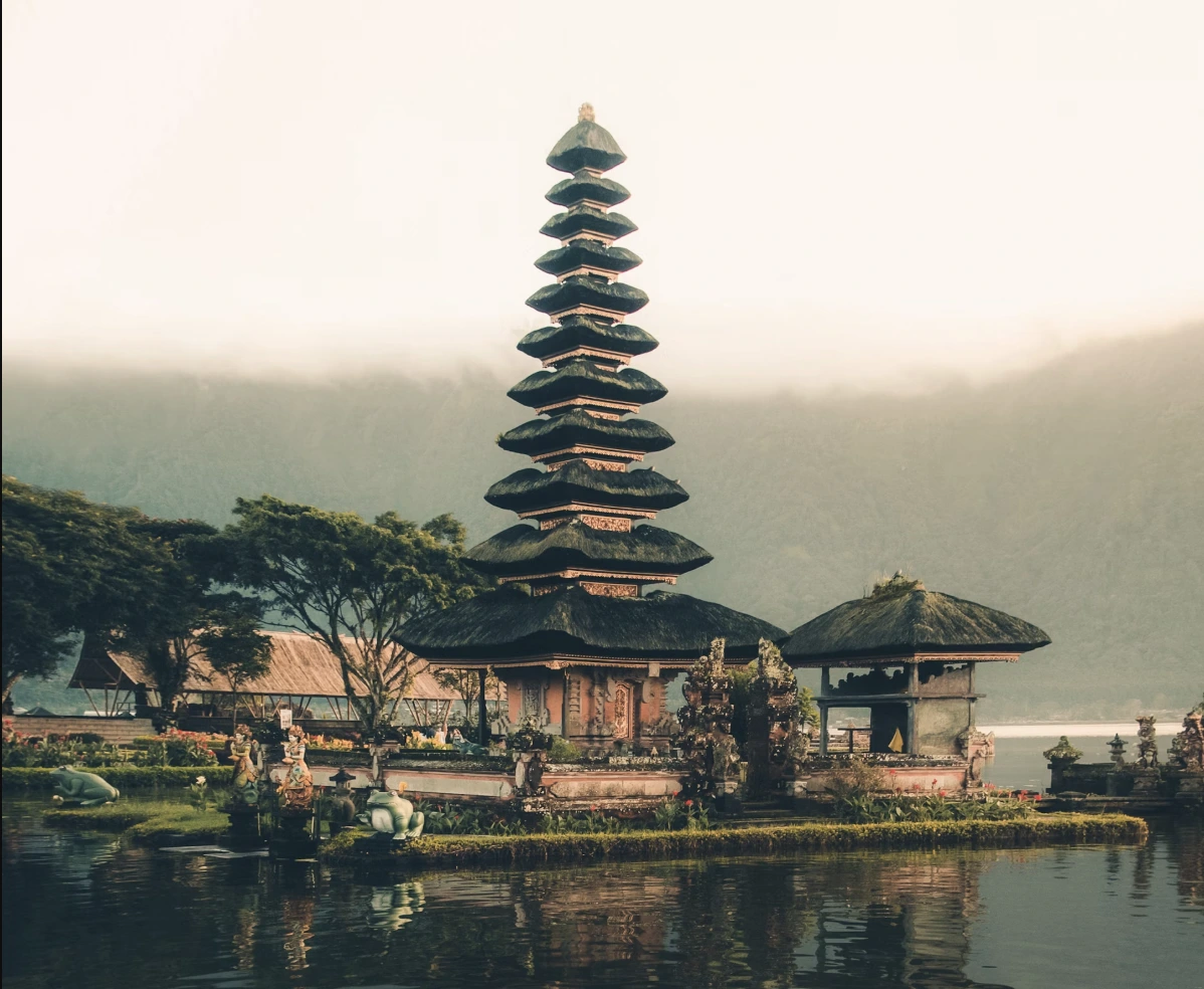 Scenic view of Tanah Lot temple in Bali at sunset, a popular tourist destination for visitors to Indonesia.